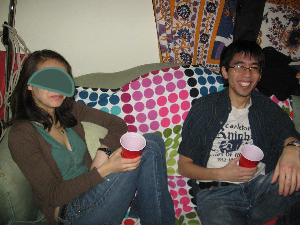 Marina sitting on a couch at a party with a red solo cup.