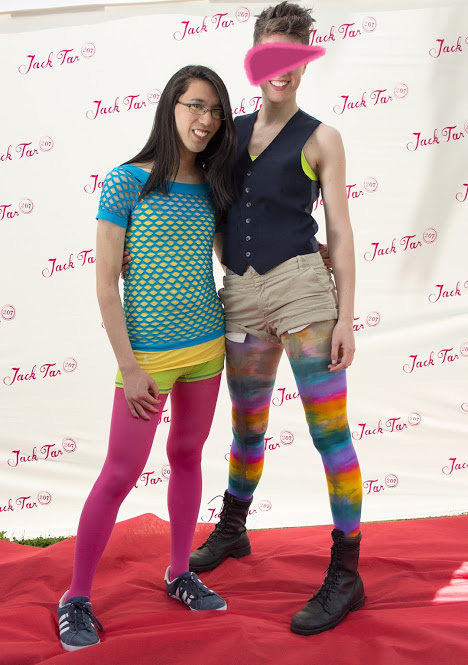 Marina and Alex in dramatic pride outfits. Nice quality photo from a Pride photobooth.
