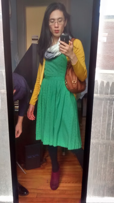 Another selfie of Marina's outfit. She's wearing a green dress with a mustard yellow cardigan and a white and grey scarf.