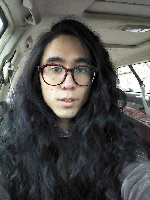 Marina sitting in a car with dramatic wavy hair (from taking out a french braid after leaving it in for several days)