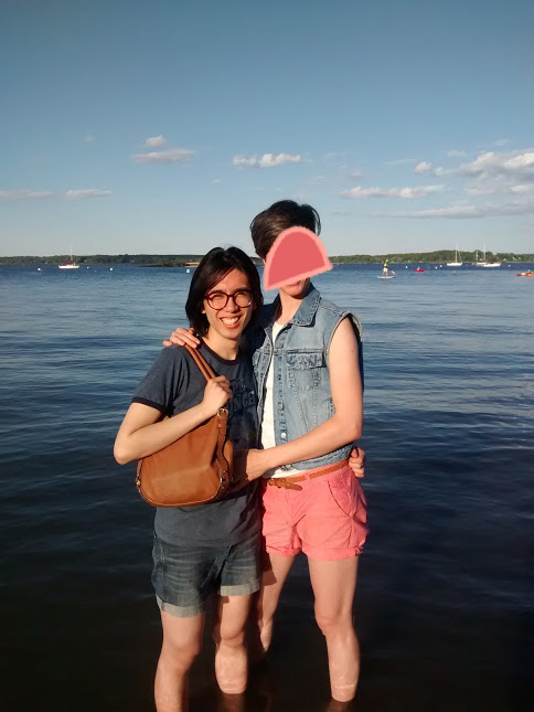 Cute photo of Marina and Alex standing in the Atlantic Ocean on a sunny day.