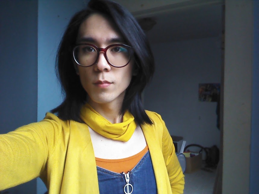 Marina wearing a jean dress with a yellow cardigan and yellow neck bandanna.